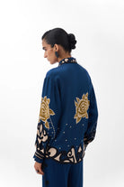 NOIB Iris Old Rose blue printed shirt with large gold floral motifs on sleeves and back – rear model view.