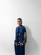 NOIB Iris blue floral print long sleeve shirt with contrasting dark trim – three-quarter model view.