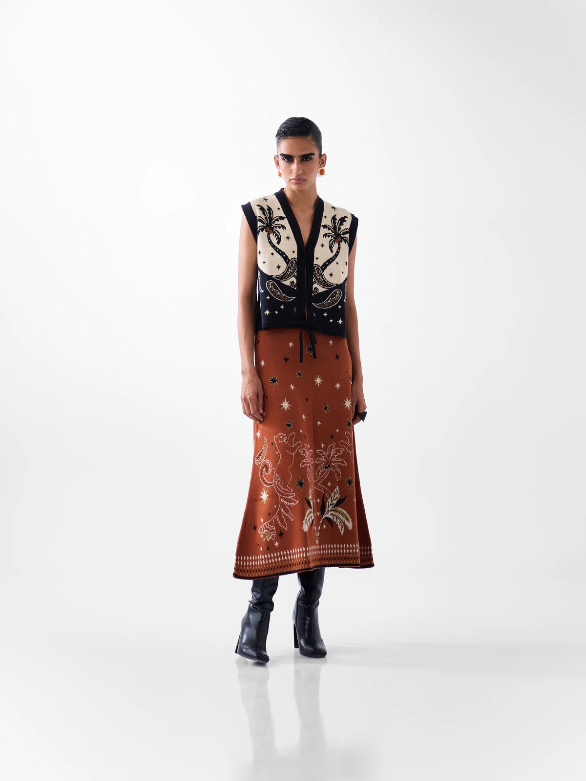 NOIB Lola Nocturnal Jungle tie-front knitted waistcoat worn with matching patterned skirt and boots – front outfit view.
