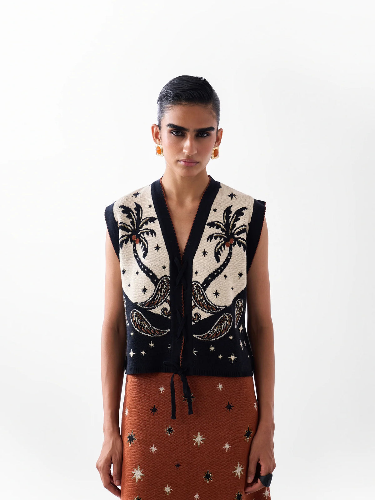 NOIB Lola Nocturnal Jungle black and ivory jacquard knitted waistcoat with palm tree motifs – front model view.