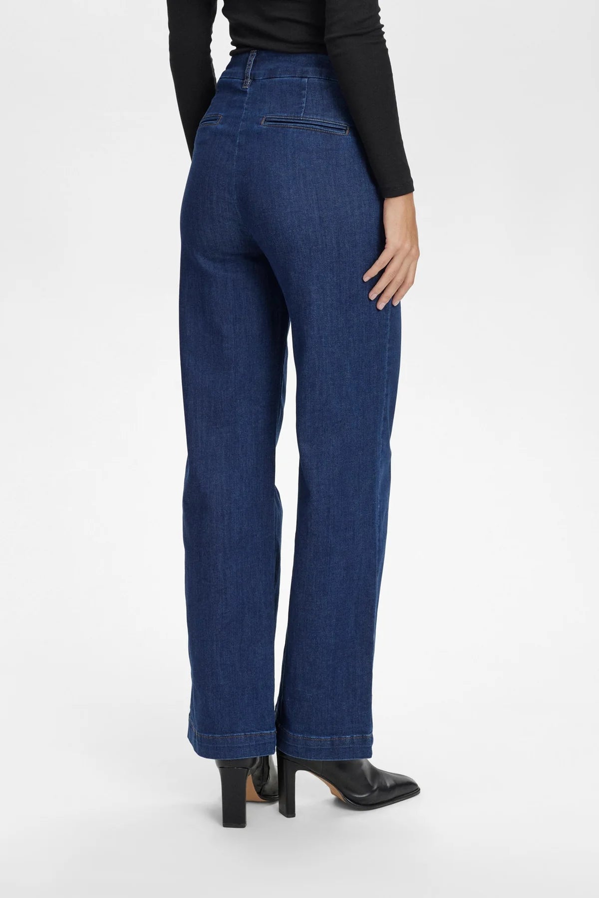 Back view of Nümph Nuamber flared denim jeans in dark blue, high-rise fit with welt pocket detail.