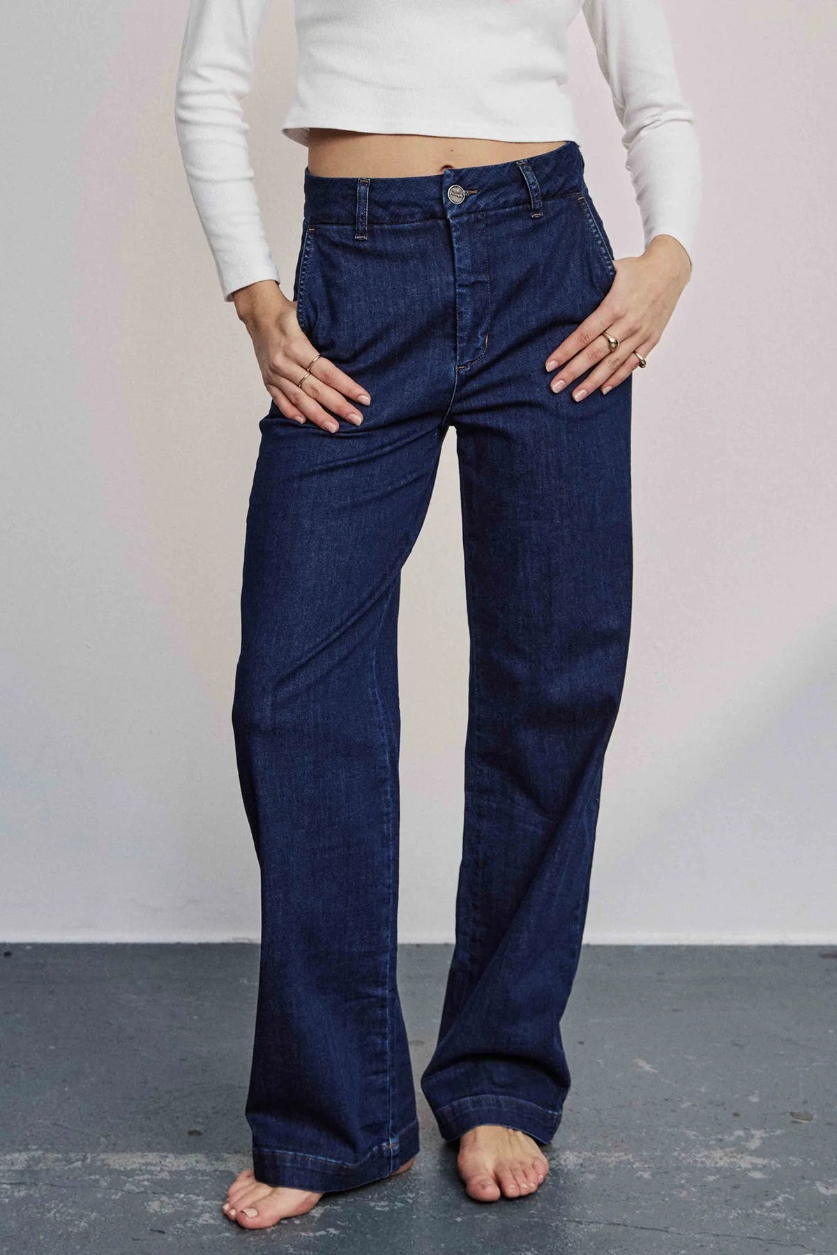Model wearing Nümph Nuamber wide-leg flared jeans in dark blue denim, high-rise fit, full length.