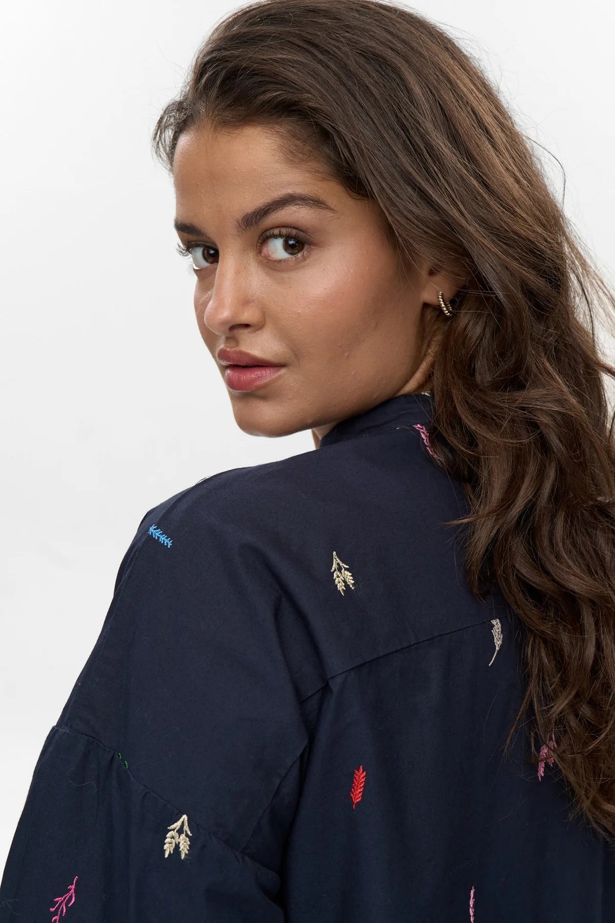 Close-up of multicolour leaf embroidery on Numph Nukiva dark sapphire shirt