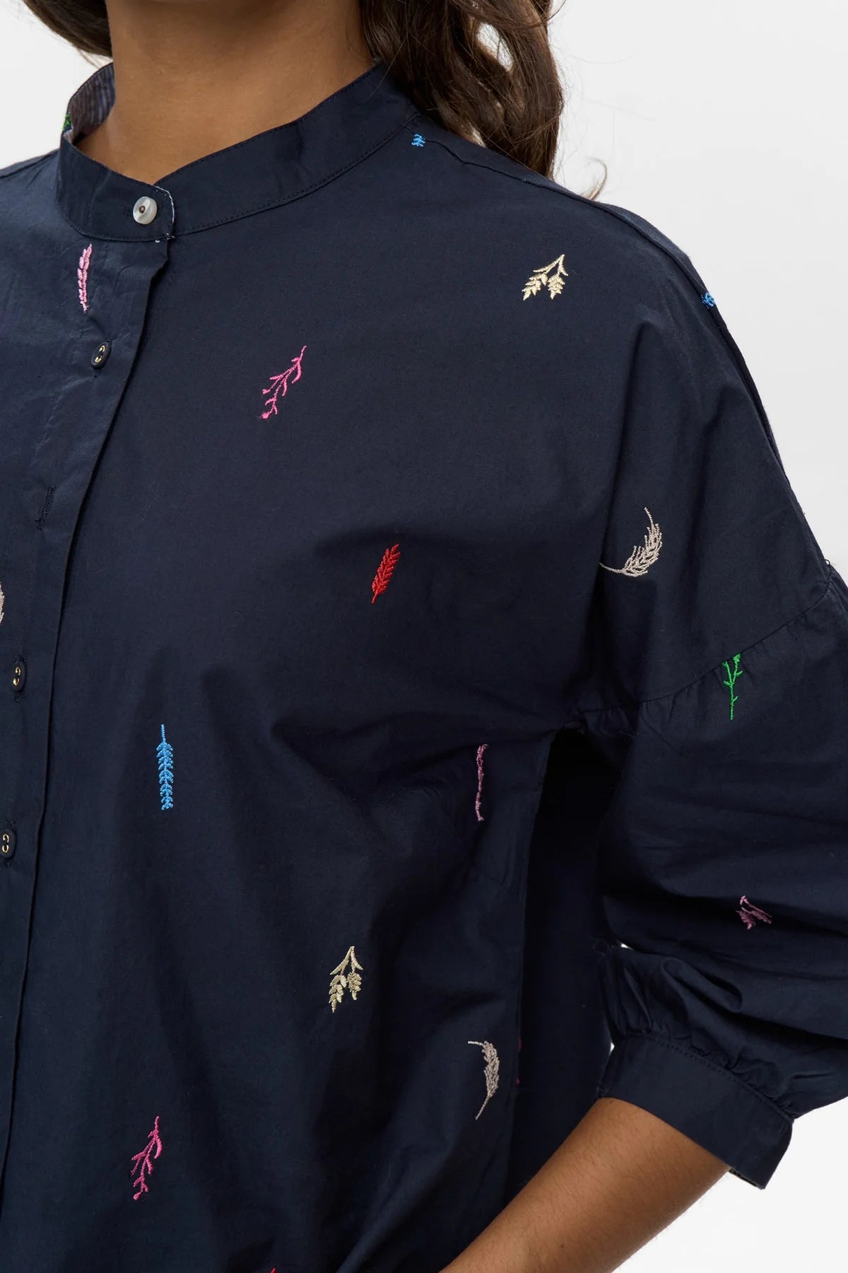 Detail shot of mandarin collar and embroidery on navy Numph Nukiva shirt