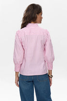 Rear view of Numph pink pinstriped shirt styled casually with denim