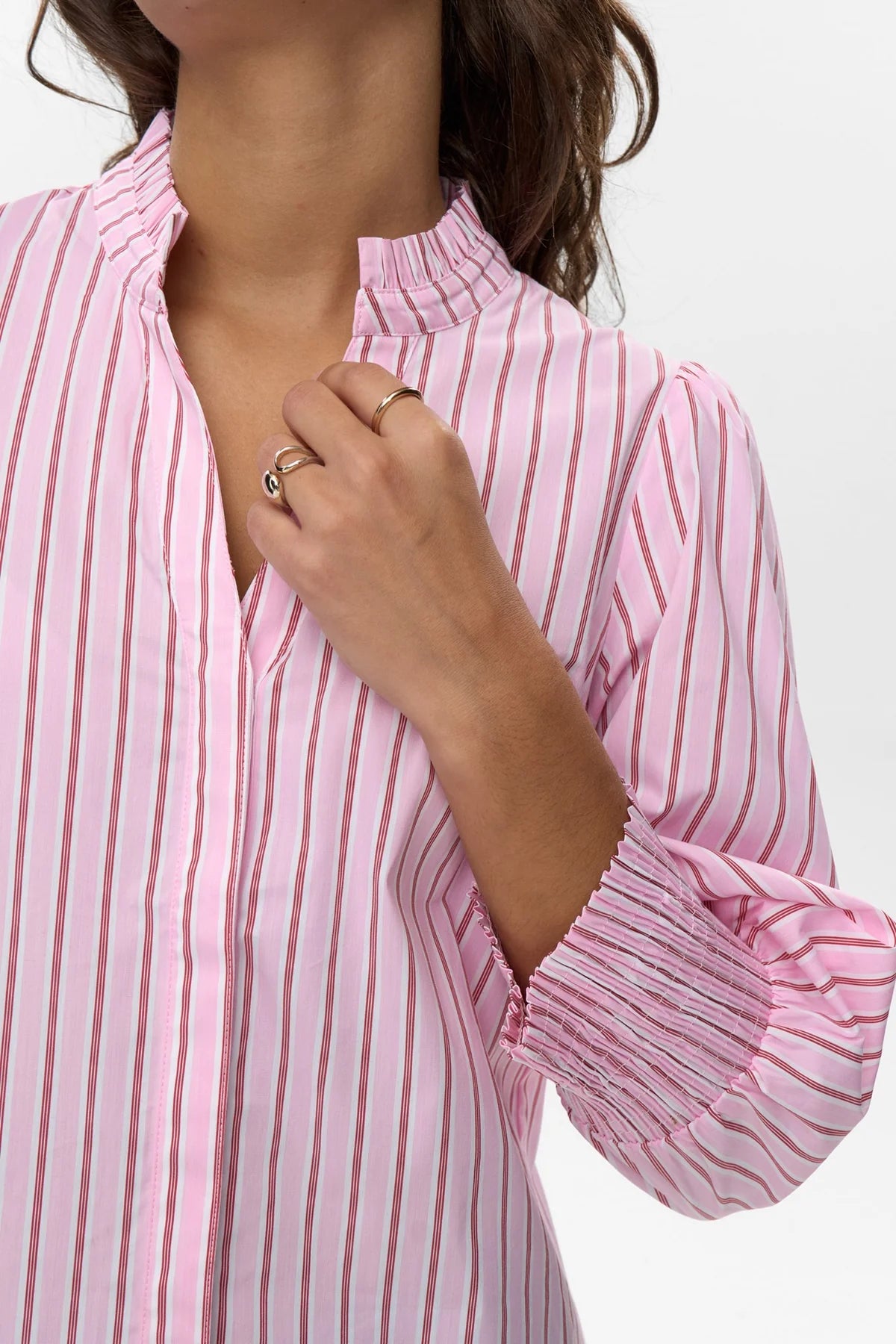 Close-up of orchid smoke pink shirt with red stripes and ruffle collar