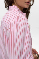 Side view of Numph Nusavas shirt with smocked cuffs and stripe detail