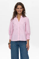 Model in pink pinstripe cotton blouse with puff sleeves and jeans