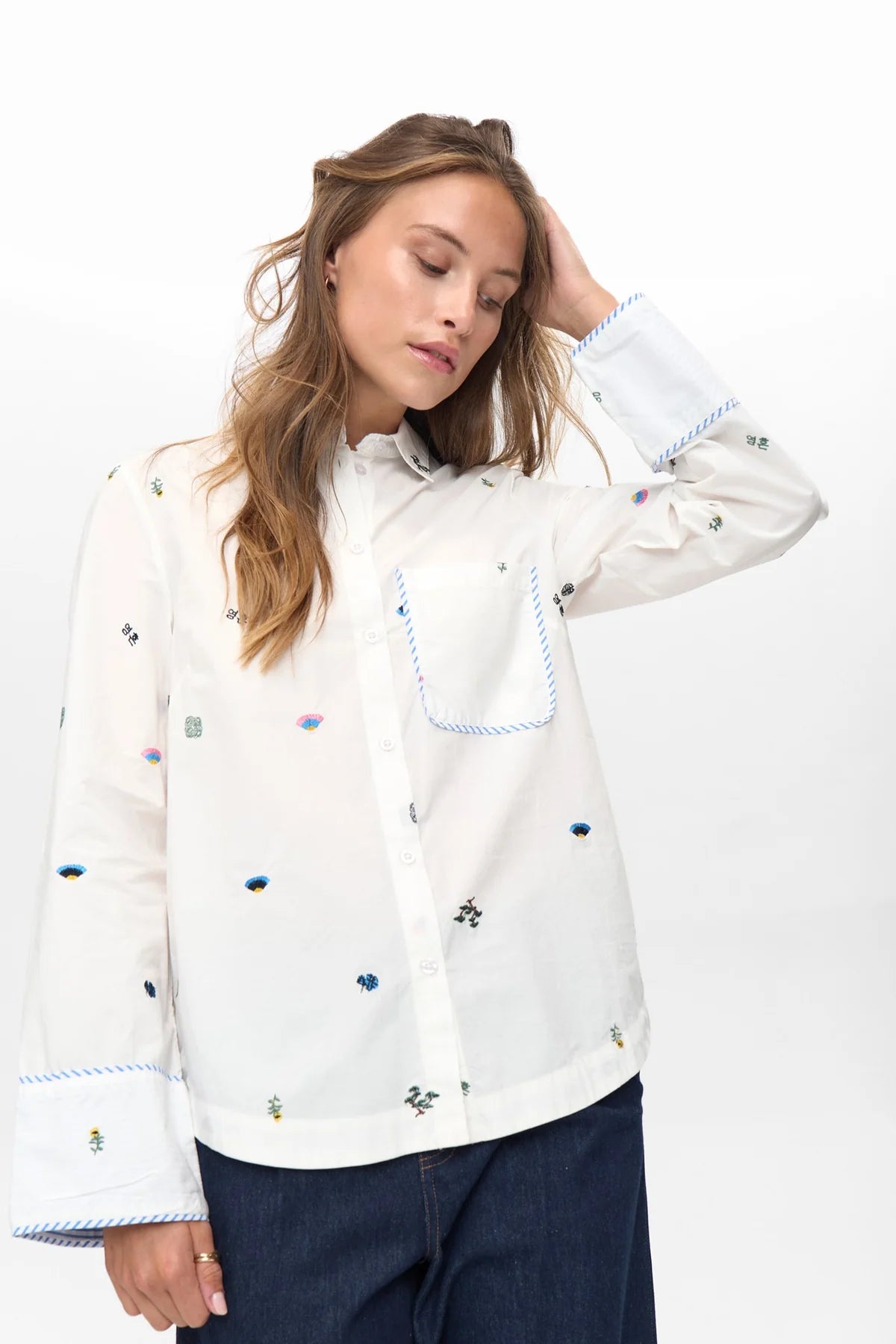 Numph Nuchiro shirt wide cuffs with blue trim and floral embroidery.