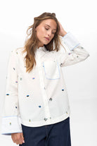 Numph Nuchiro shirt wide cuffs with blue trim and floral embroidery.