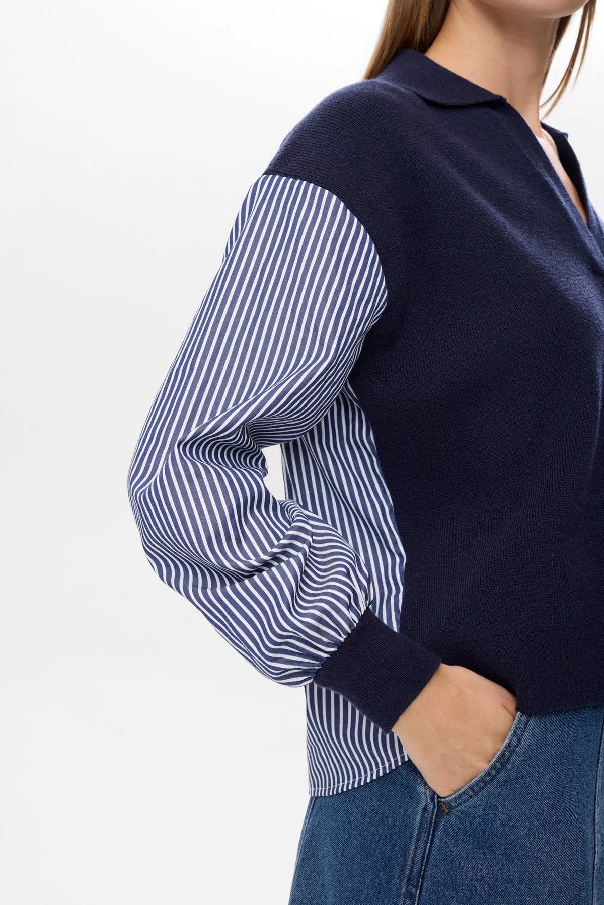Model wearing Numph Numarsy navy jumper with collar and striped shirt sleeves.