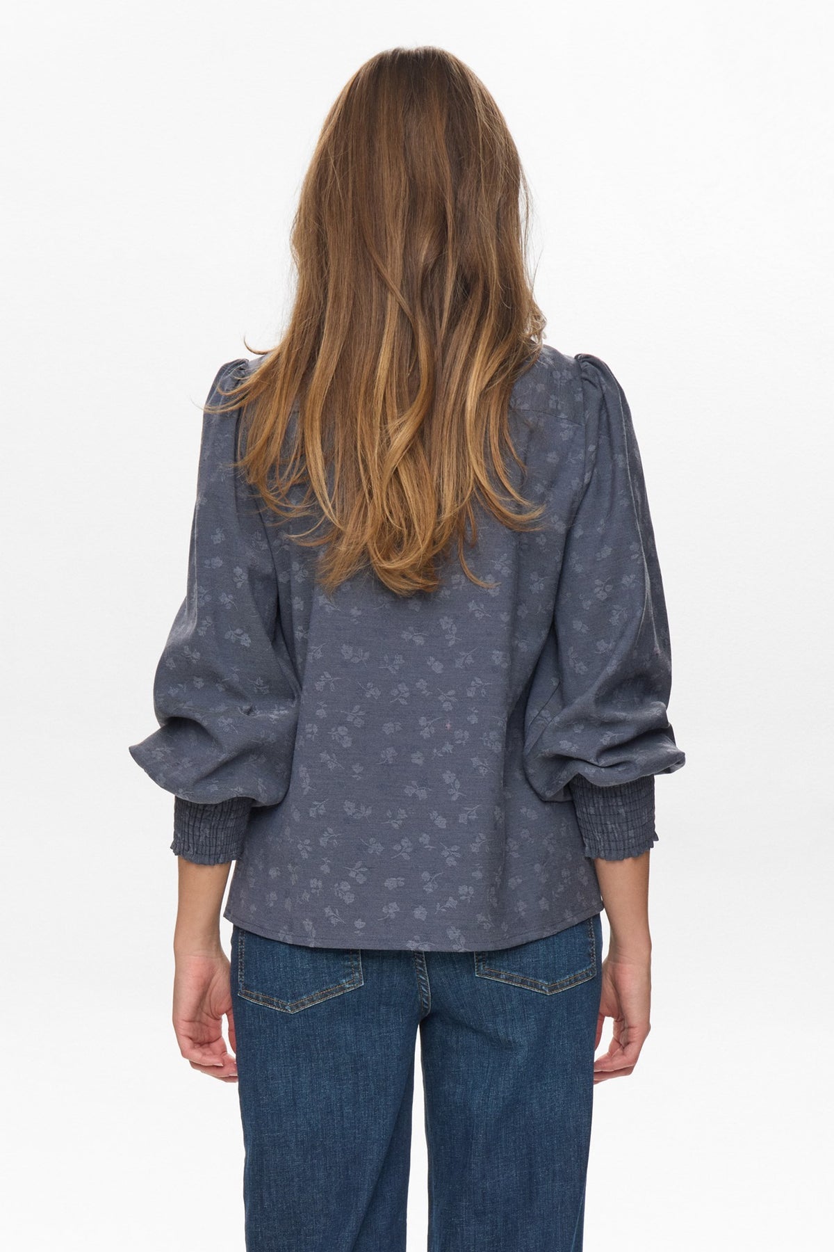 Back view of Numph Nucila Denim Blue Shirt – puffed sleeves and smocked cuffs