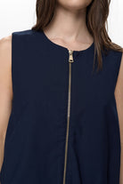 Close up of Numph Nujulia gold zip fastening on navy vest top