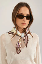 Numph fairytale print scarf tied loosely around neck 