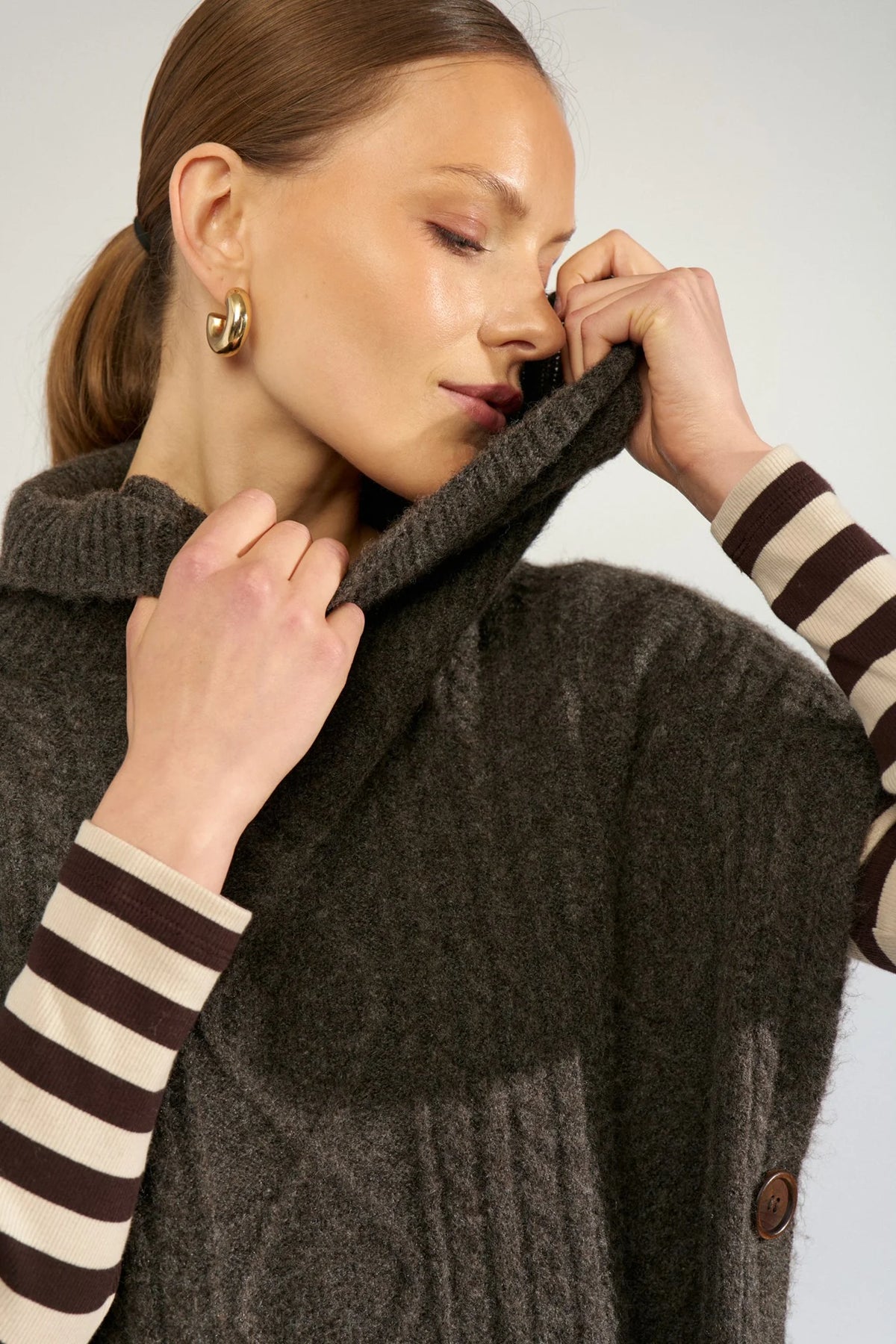 Nümph Nujoline brown cable knit poncho with soft roll neck – close model view