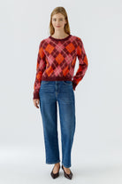 Oui bright blue barrel leg jeans styled with argyle jumper – front model view