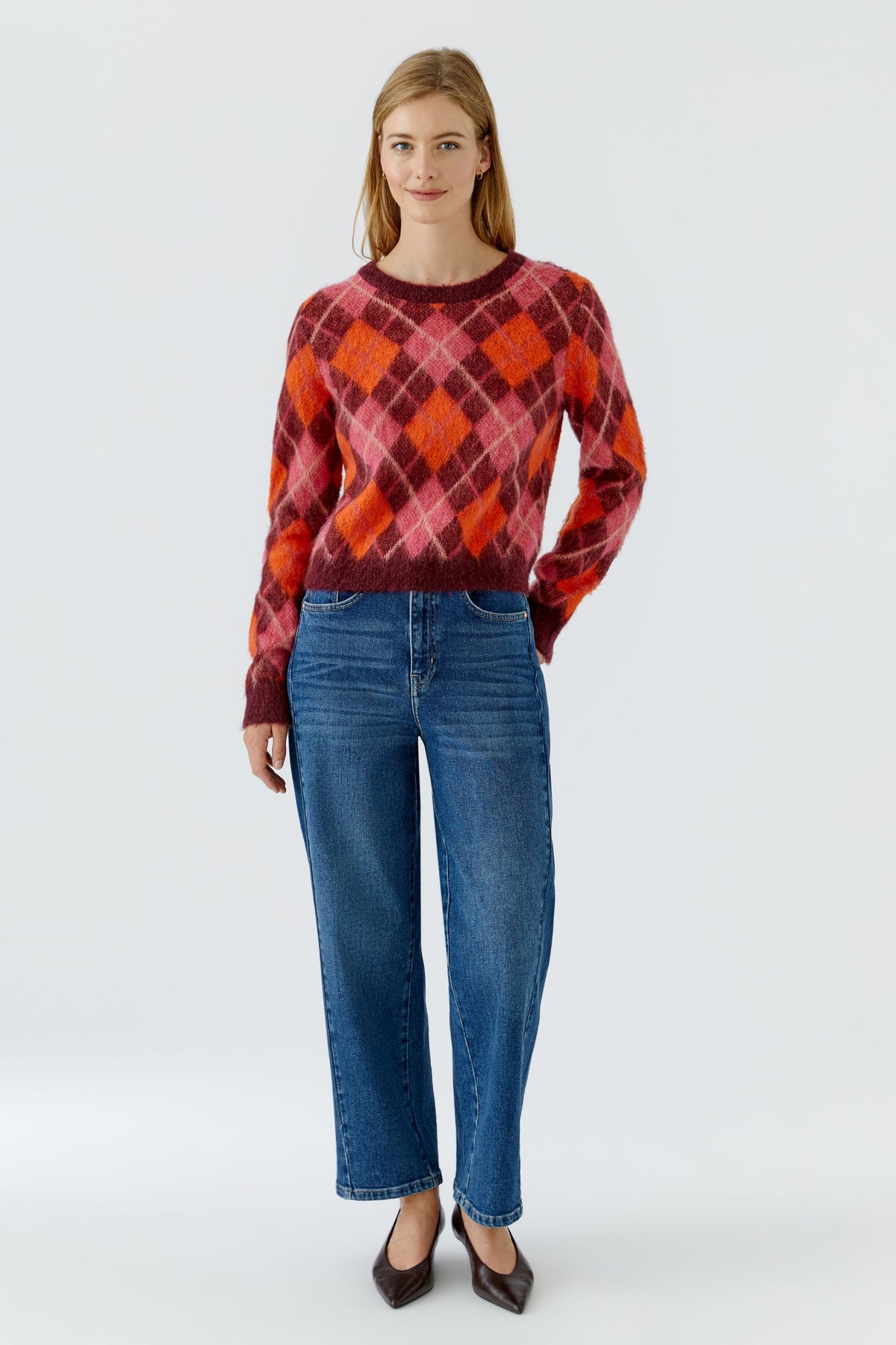 Oui bright blue barrel leg jeans styled with argyle jumper – front model view