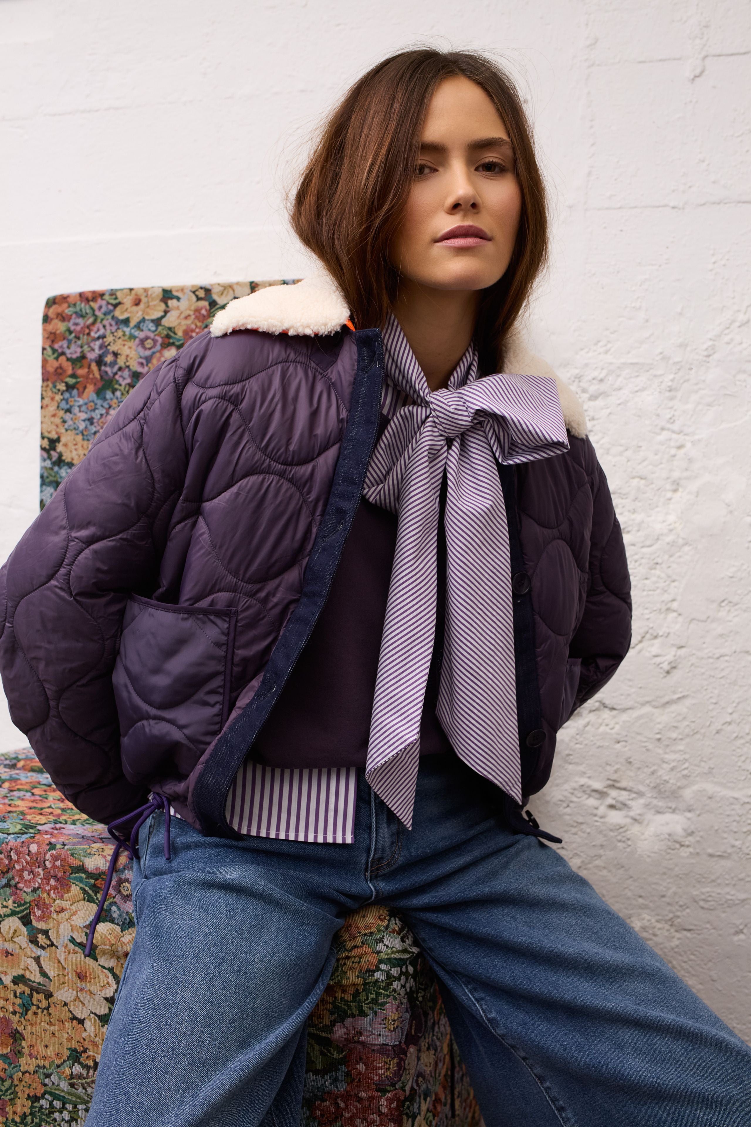 Oui violet and white striped pussy bow blouse layered under purple jacket – lifestyle view