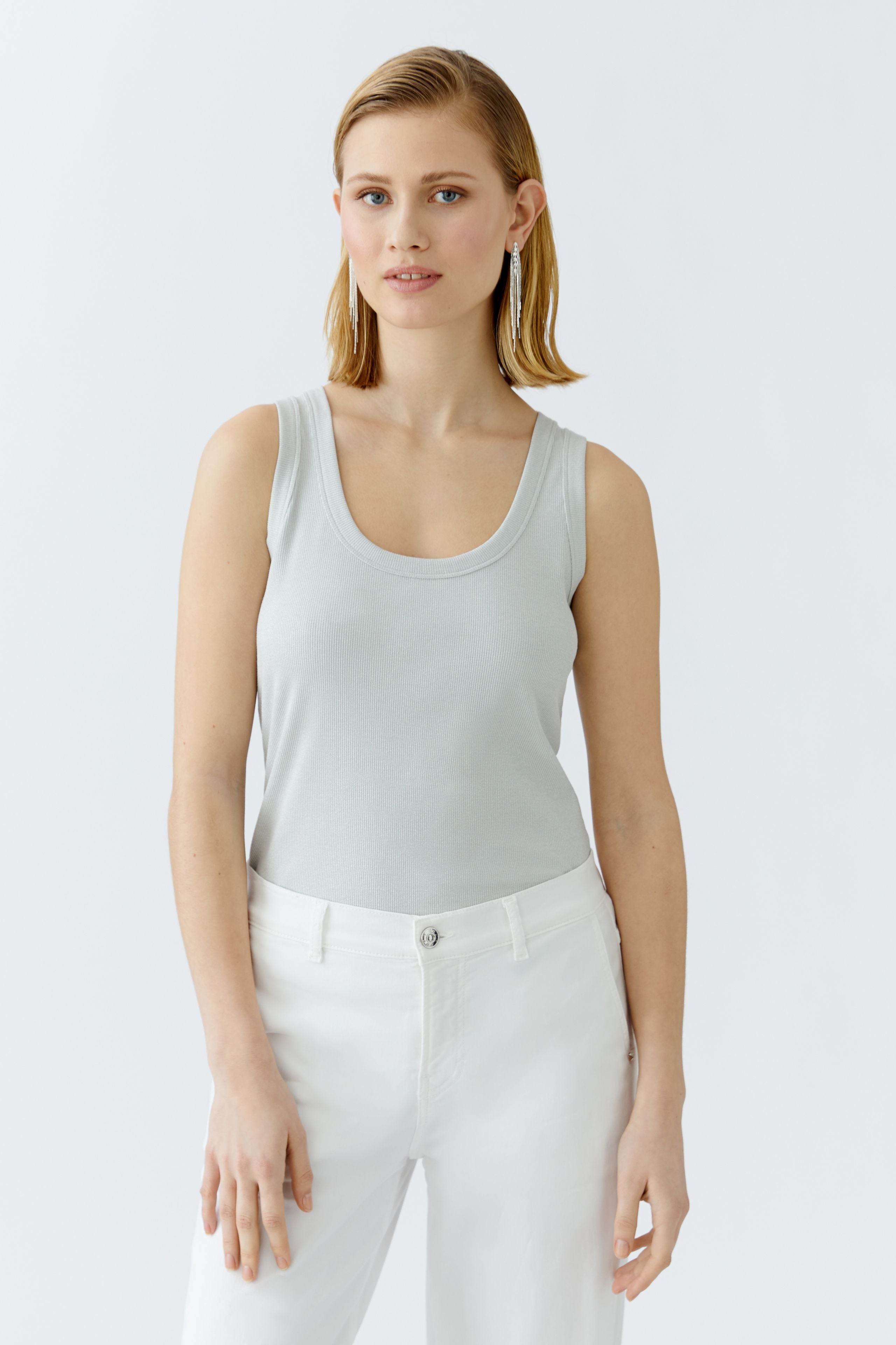Model wearing slim-fit grey shimmer tank by Oui