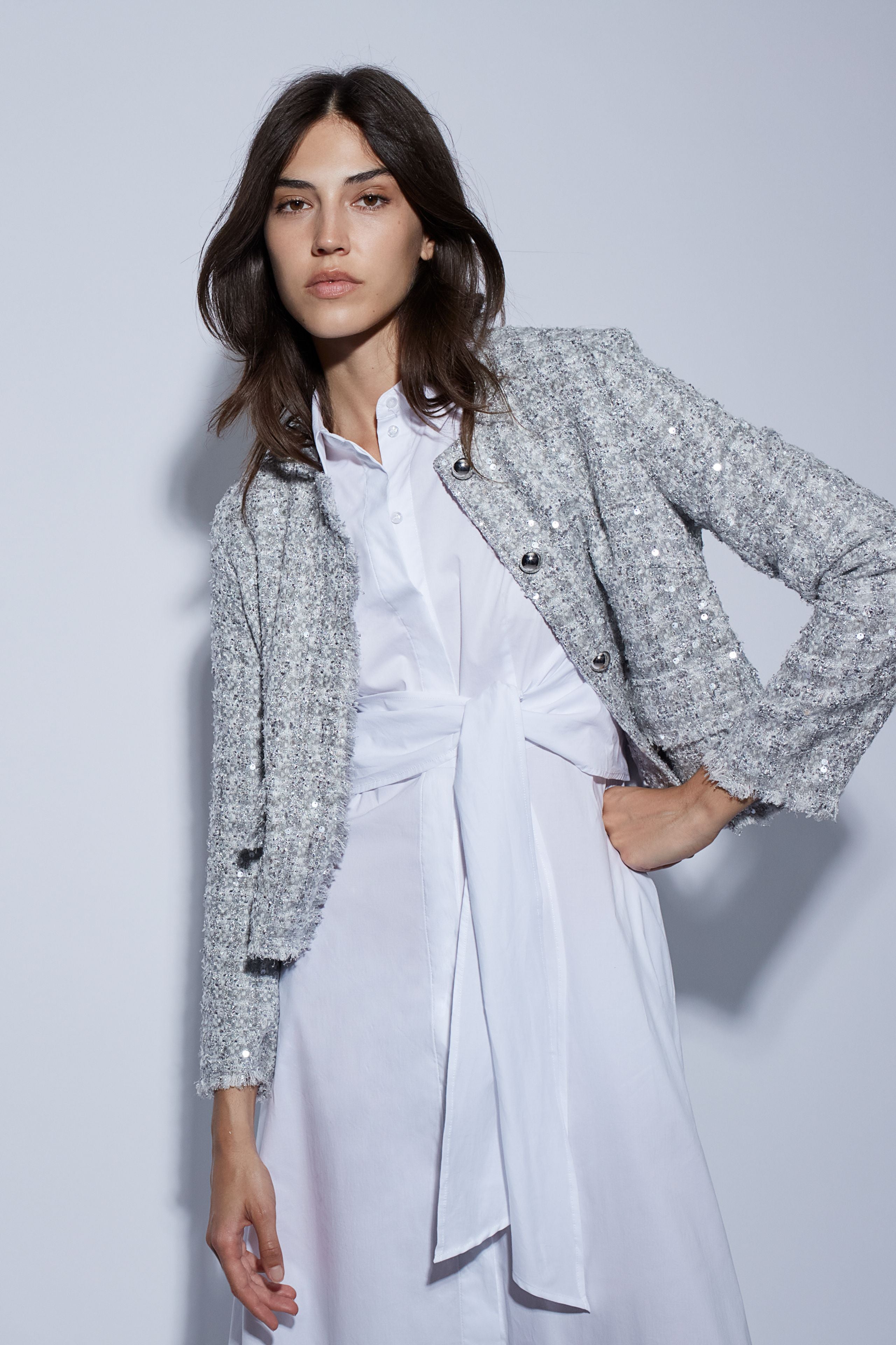 Model in white shirt dress layered with Oui cropped summer jacket