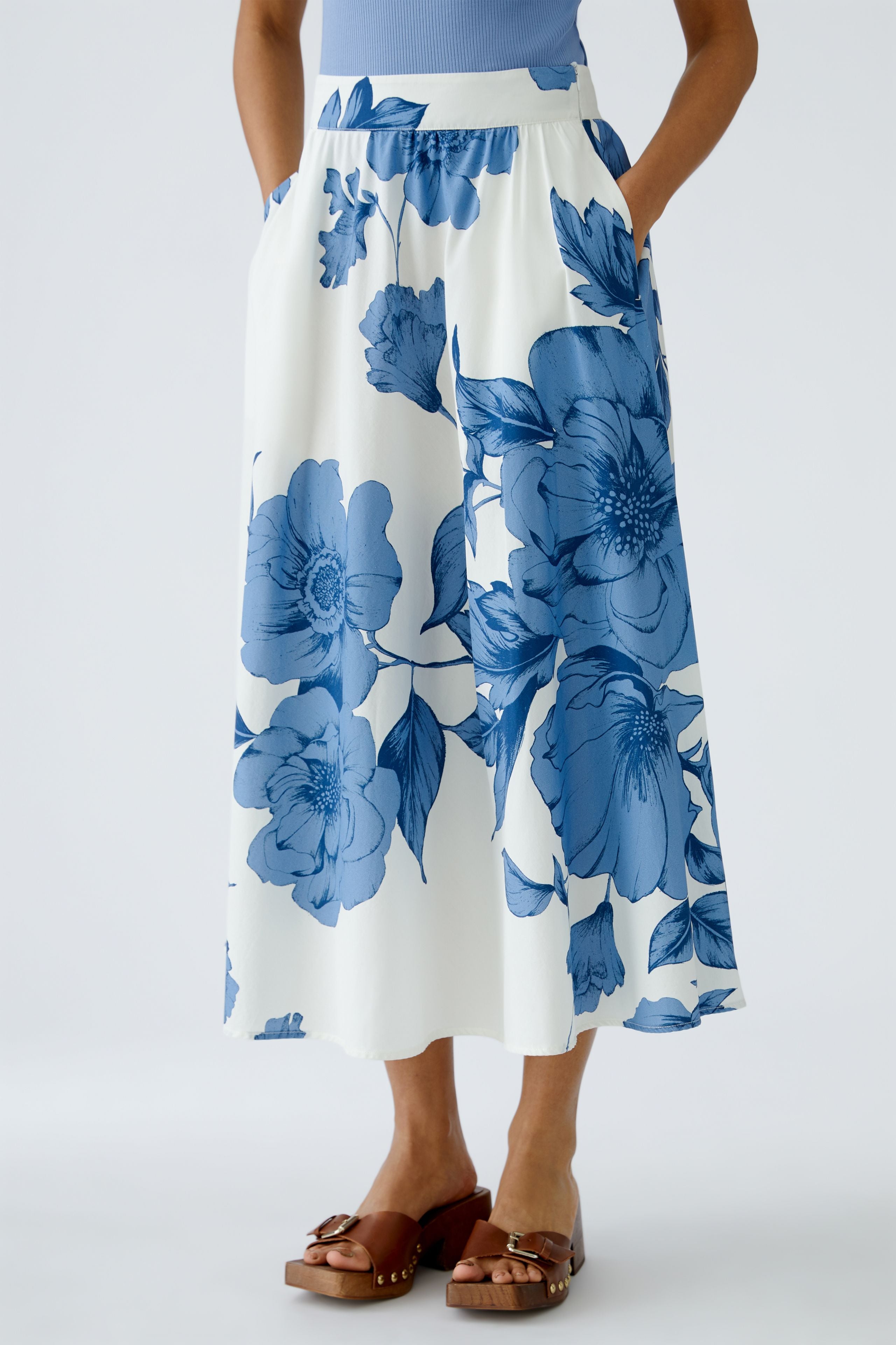 Blue and white floral midi skirt – styled with tan sandals, cropped front view.