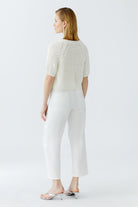 Back view of cropped short-sleeve knit cardigan in white
