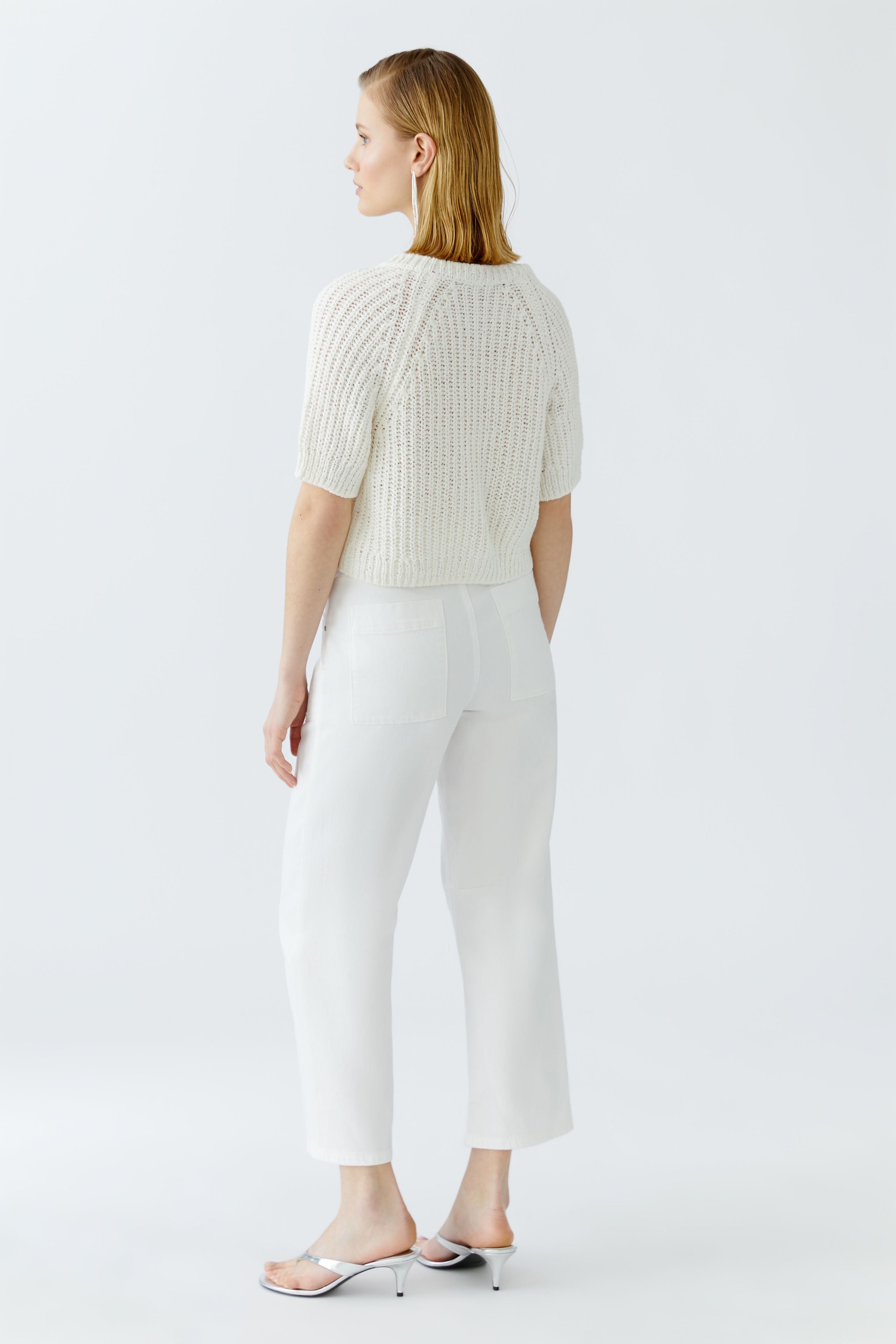 Back view of cropped short-sleeve knit cardigan in white