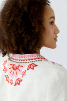 Back view of Oui bolero jacket with red flower and vine embroidery