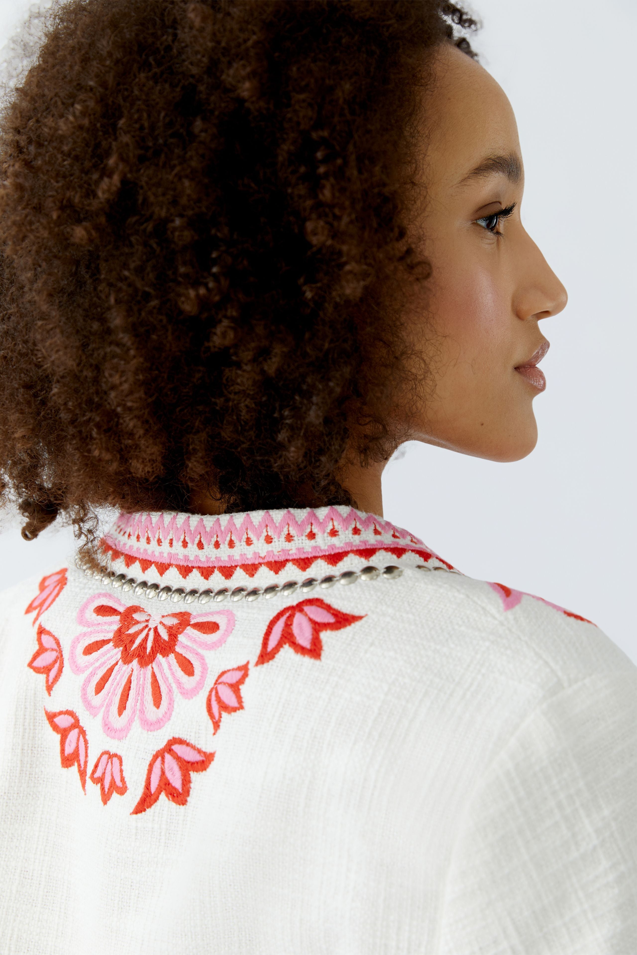 Back view of Oui bolero jacket with red flower and vine embroidery