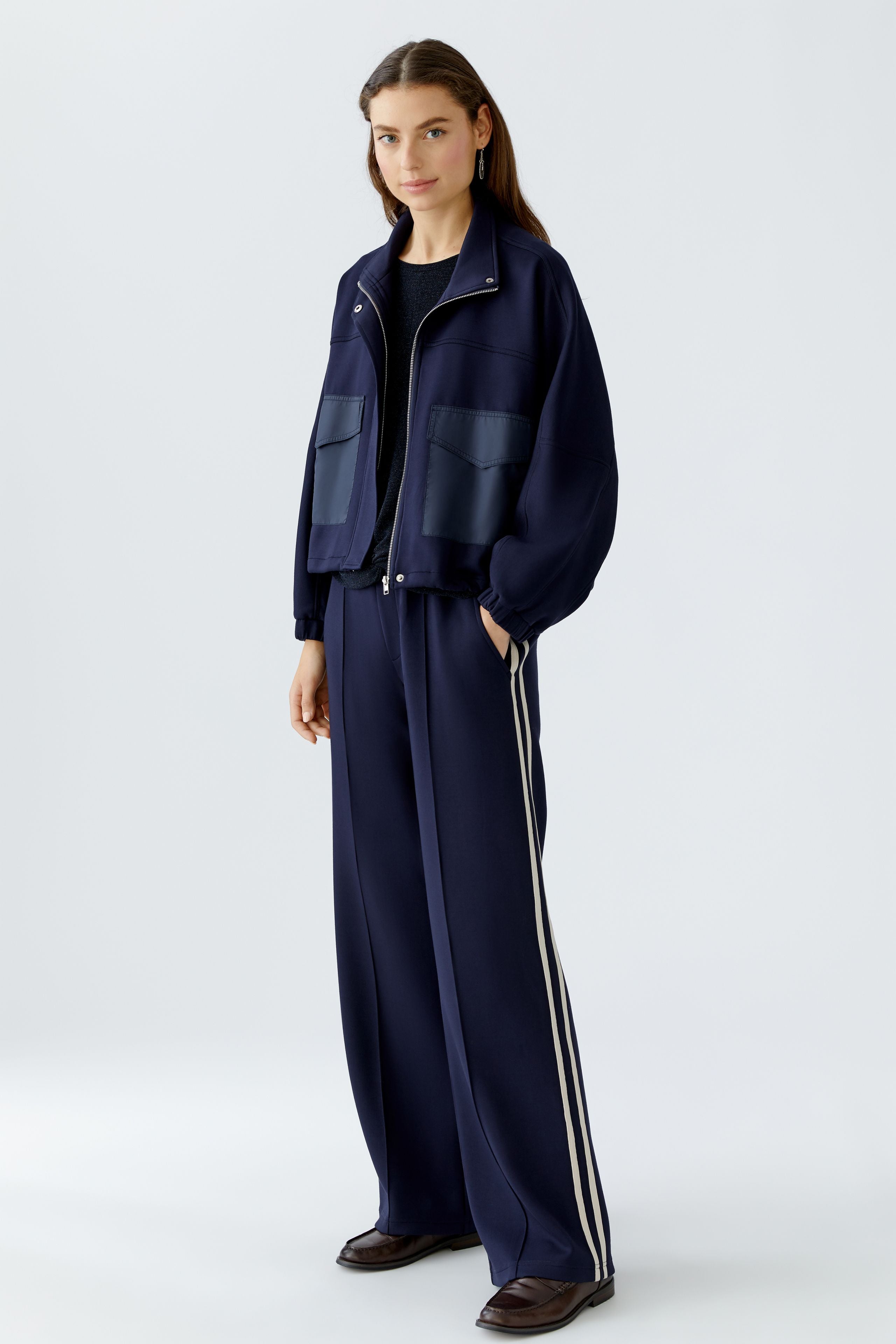 Full look with model in matching Oui jacket and trousers, hands in pockets