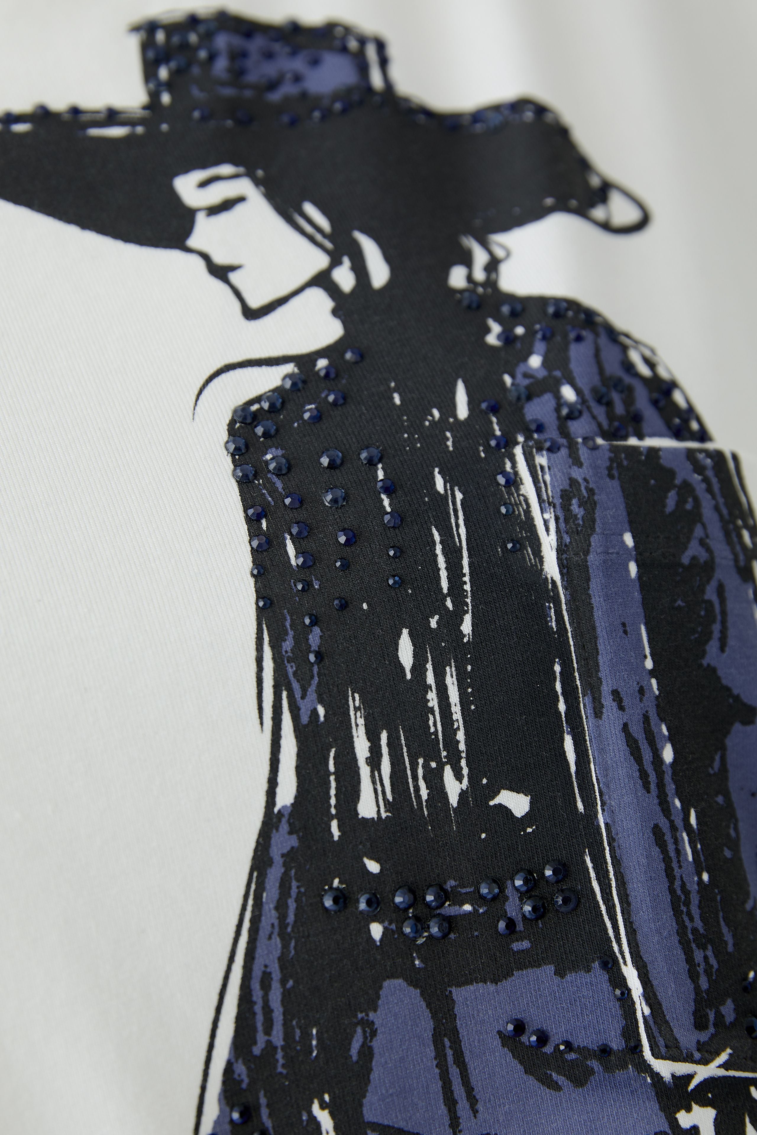 Detailed view of graphic and overprinted chest pocket on white Oui t-shirt