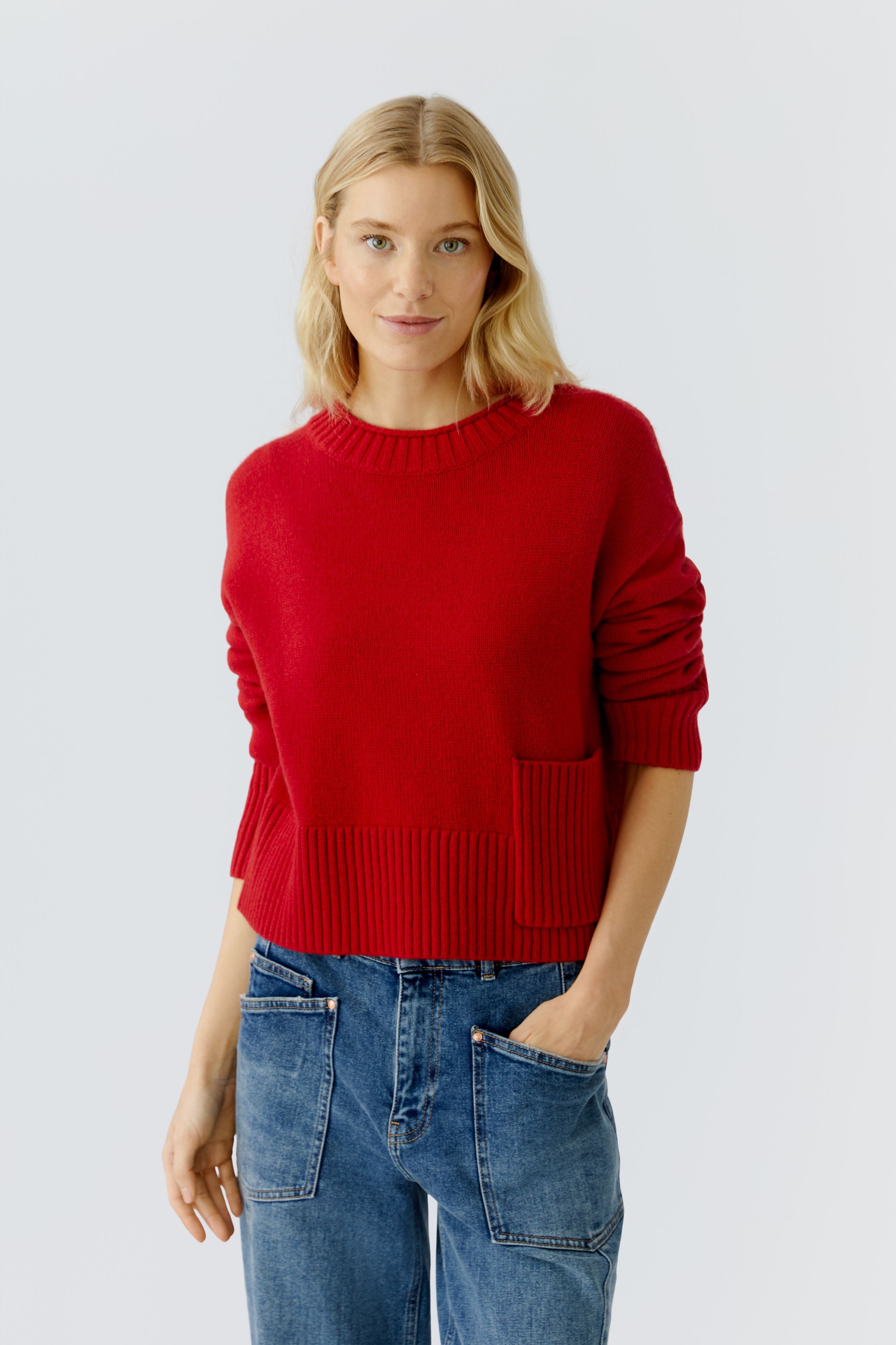 Oui red wool blend jumper styled with jeans, full outfit view