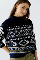 Side view of Oui Norwegian print jumper paired with olive trousers