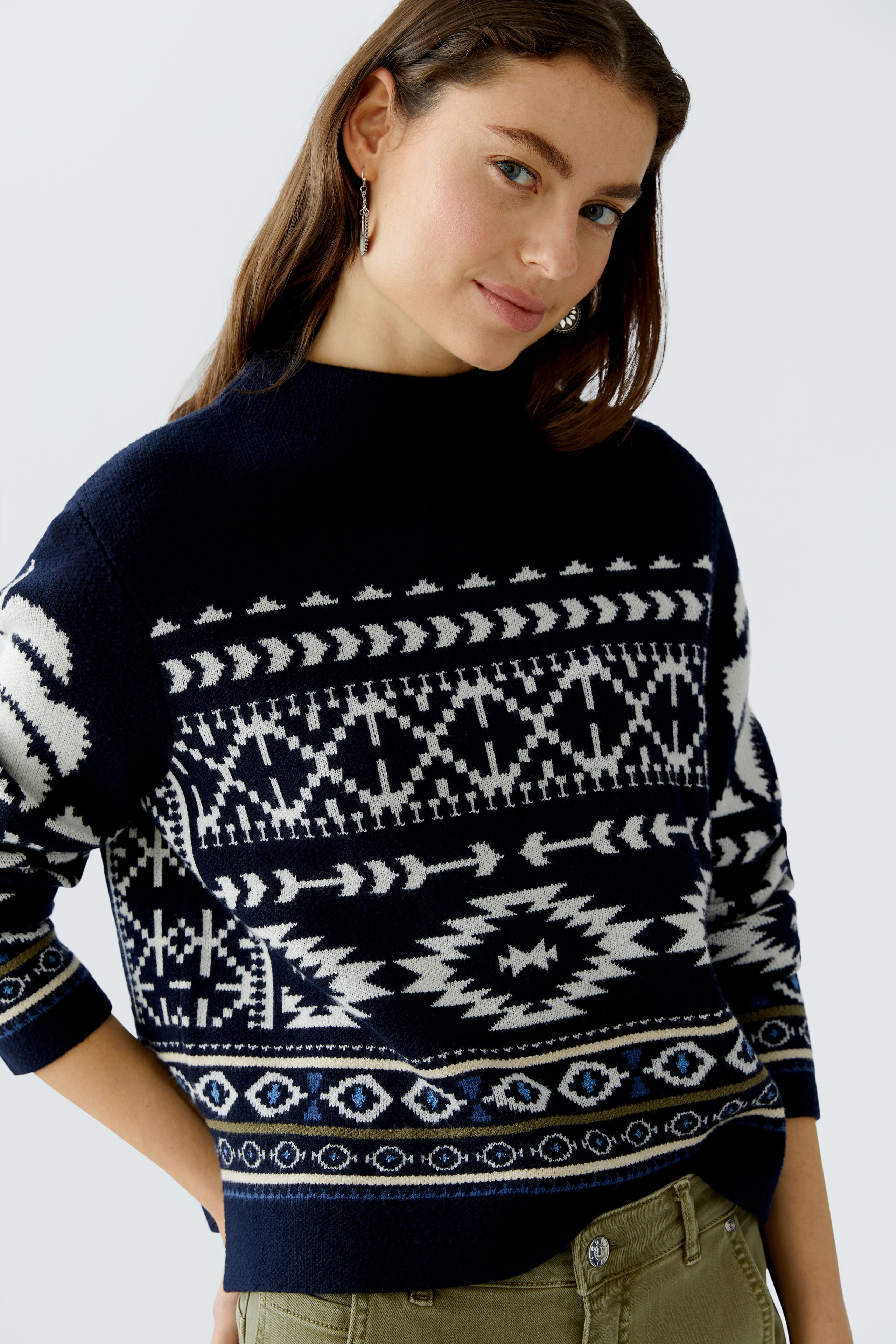 Side view of Oui Norwegian print jumper paired with olive trousers