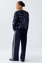 Back 3/4 view of sequin jacket showing drape and texture