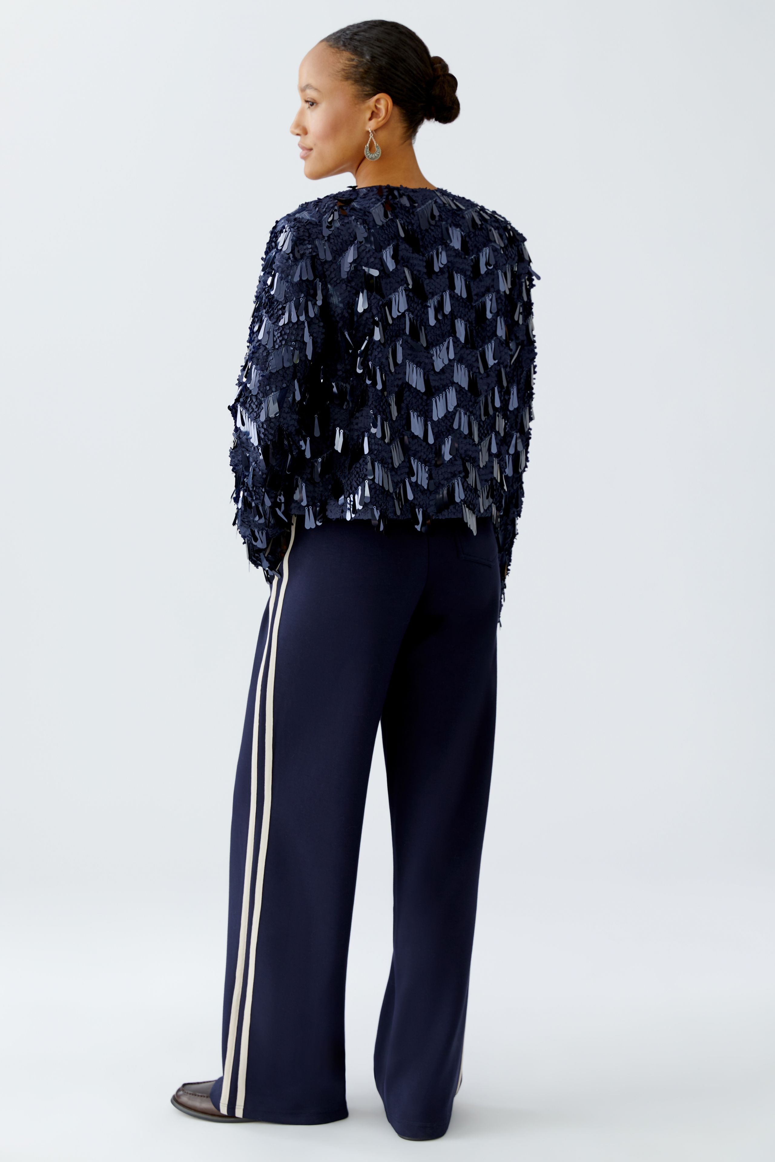 Back 3/4 view of sequin jacket showing drape and texture