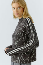 Oui sporty knitted letter print jumper side view on model, showing relaxed shape and striped raglan sleeves