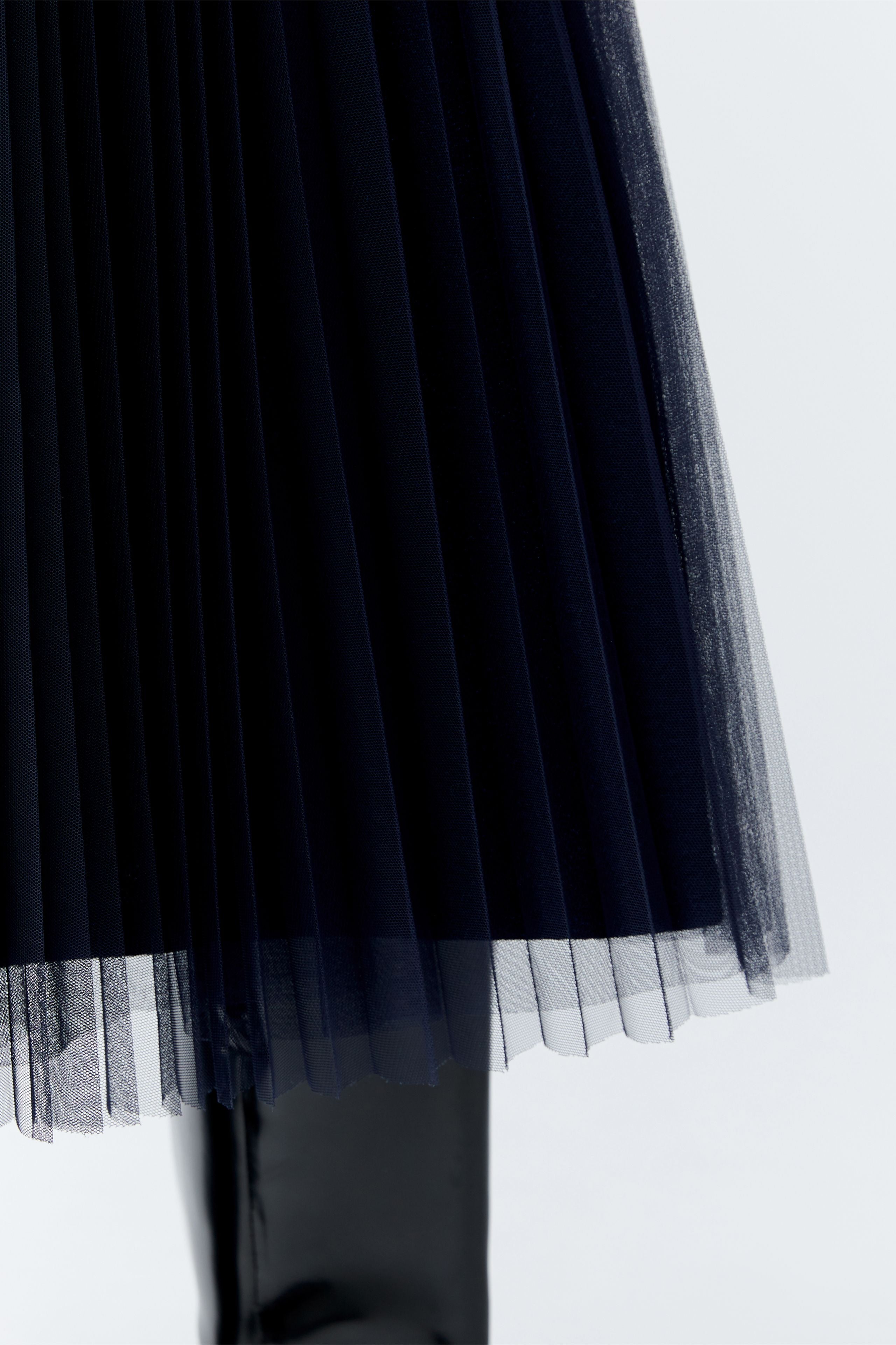 Close-up of shimmer jersey lining beneath tulle overlay