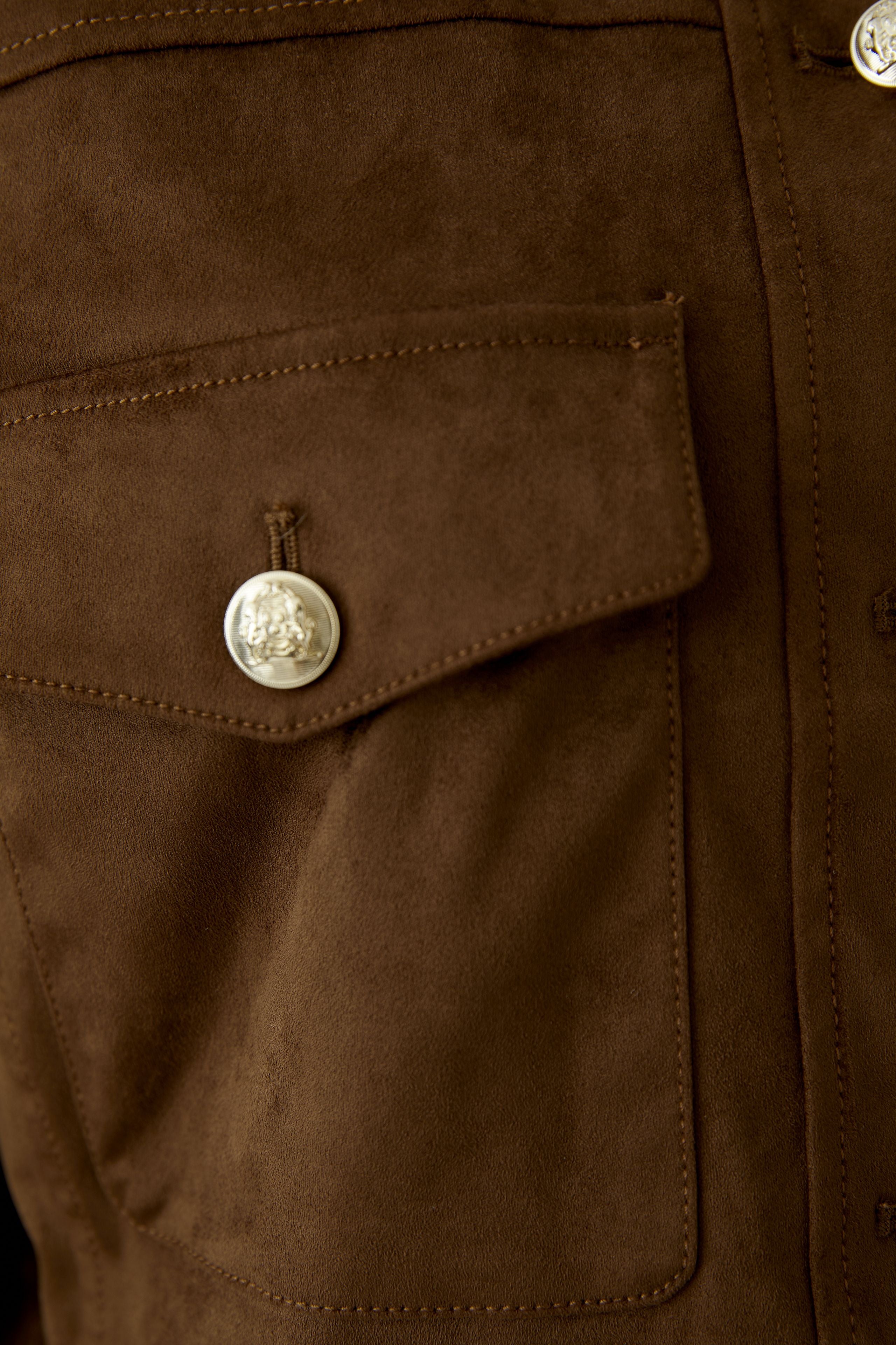 Close-up of Oui brown faux suede trucker jacket pocket and button detail