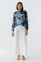 Oui floral print blouse styled with white trousers