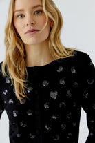 Oui black sequin cardigan close-up showing heart and abstract motifs