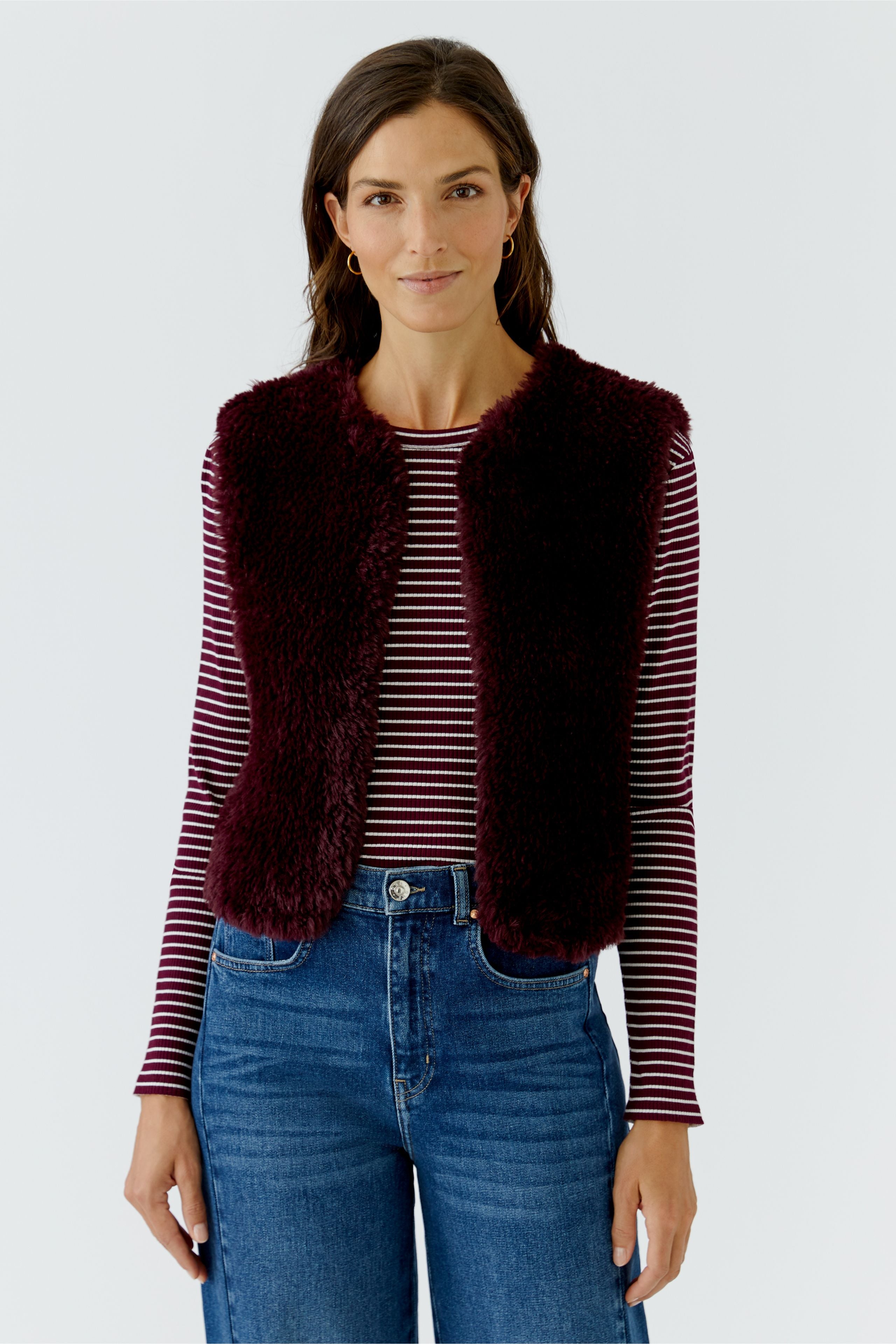 Oui burgundy short faux fur gilet layered over striped top – front detail view