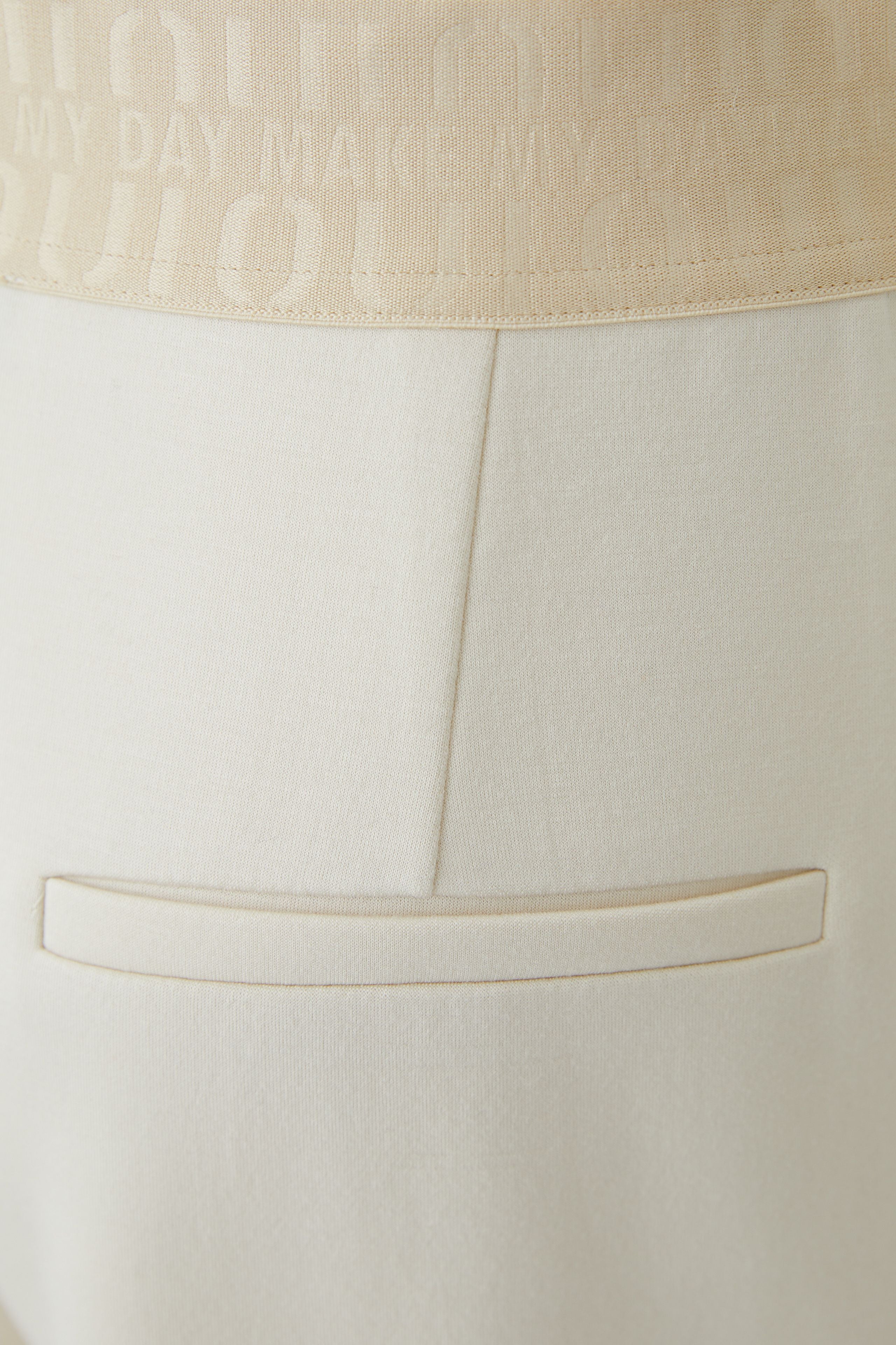 Oui cream pull-on wide leg trousers with logo elastic waistband and mock back pocket – detail view