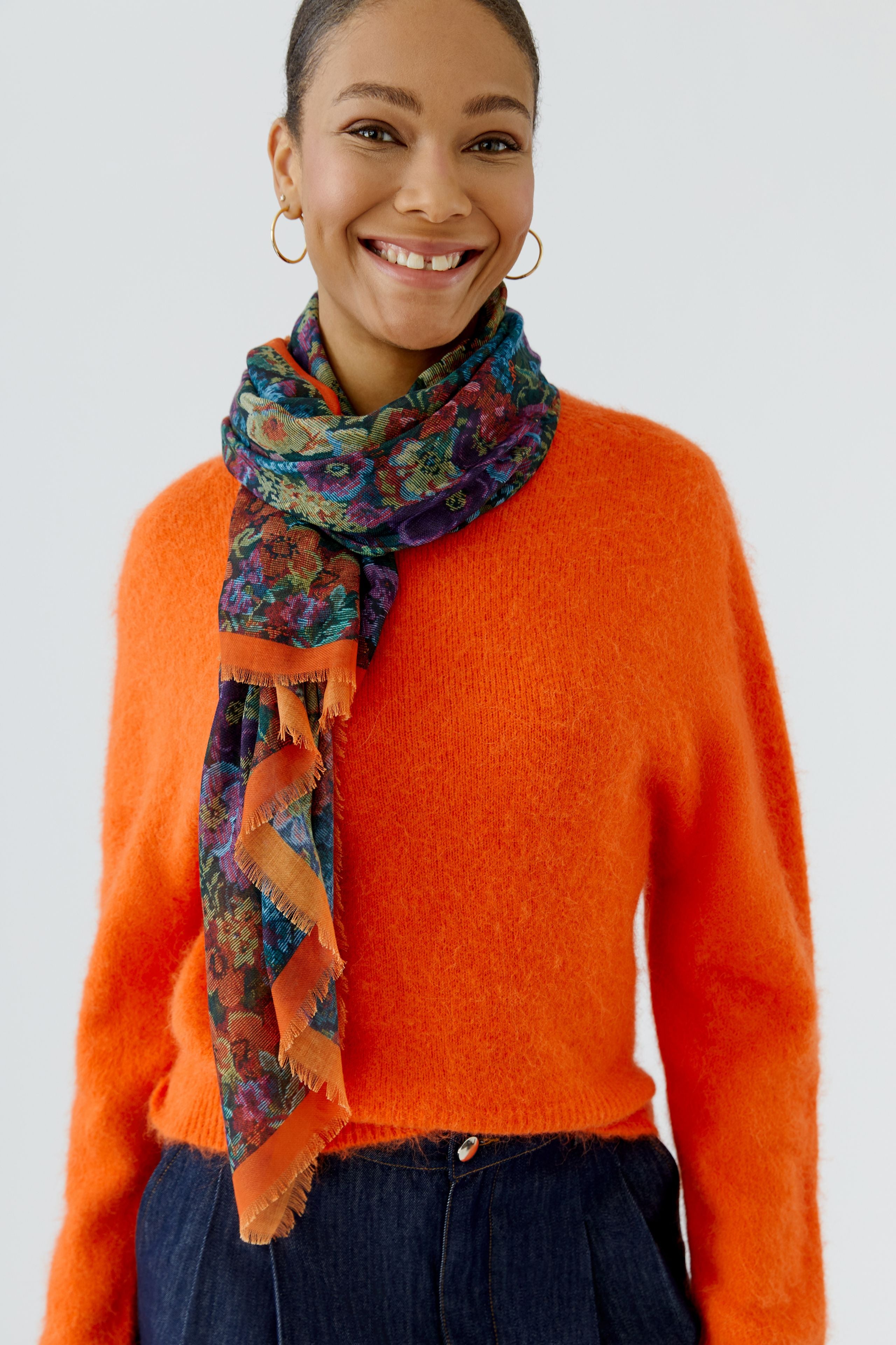 Oui multicolour floral scarf styled with orange knit on model