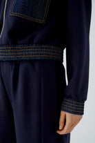 Oui navy blouson jacket with denim-trimmed cuff and elasticated hem – detail view