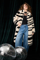 Oui black lace top styled under striped cardigan with blue jeans – lifestyle view