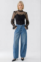 Oui black sheer lace high neck top styled with blue jeans – full front view