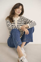 Casual striped knit cardigan paired with jeans and trainers