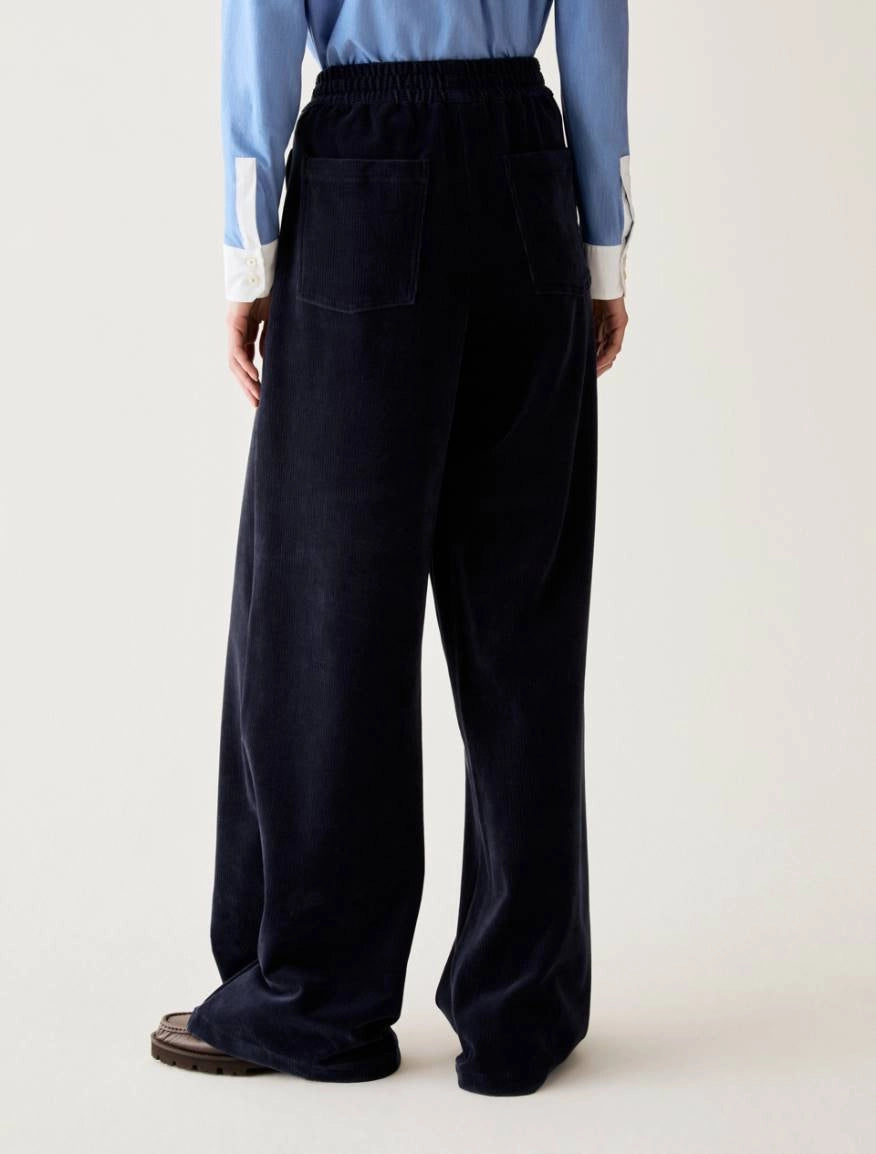 Pennyblack navy corduroy-effect joggers showing loose straight-leg fit – rear view