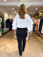 Back view of Penny Black black trousers highlighting slim fit and pocket placement